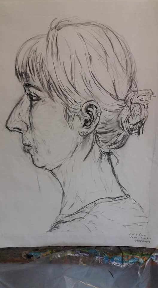 Pencil graphite profile drawing of a woman with her hair tied back
