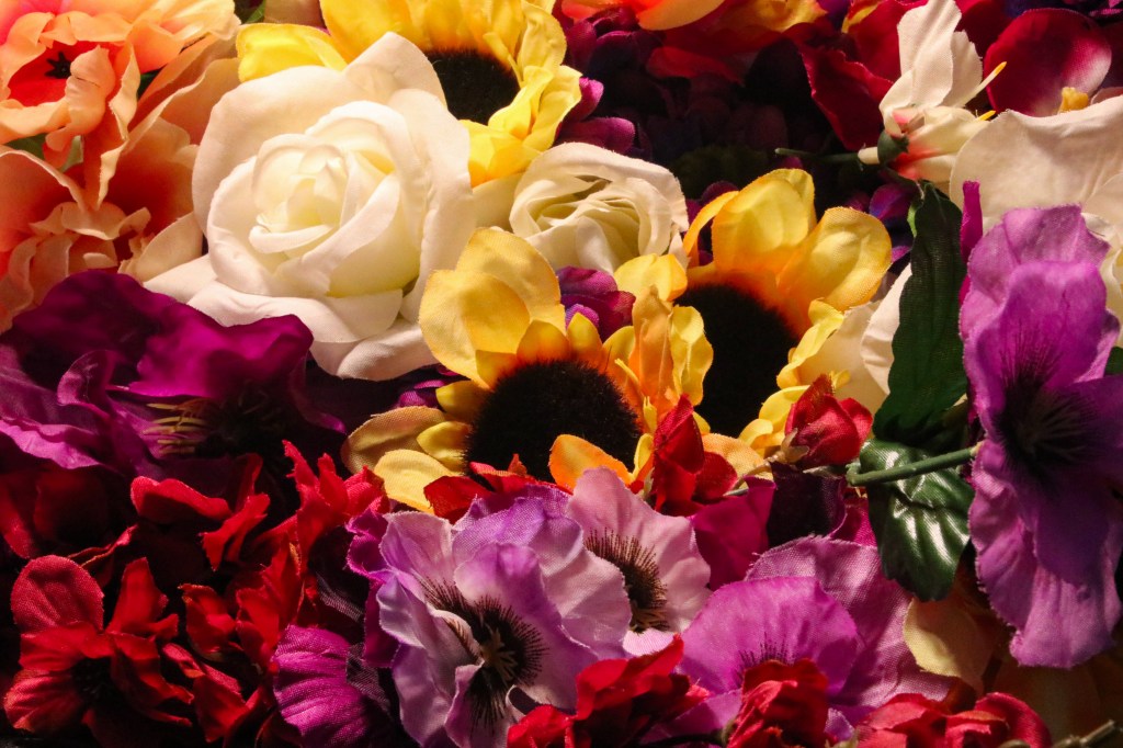 Colorful artificial flowers cropped closely, shot with a wide angle lens to exeriment with deep depth of field