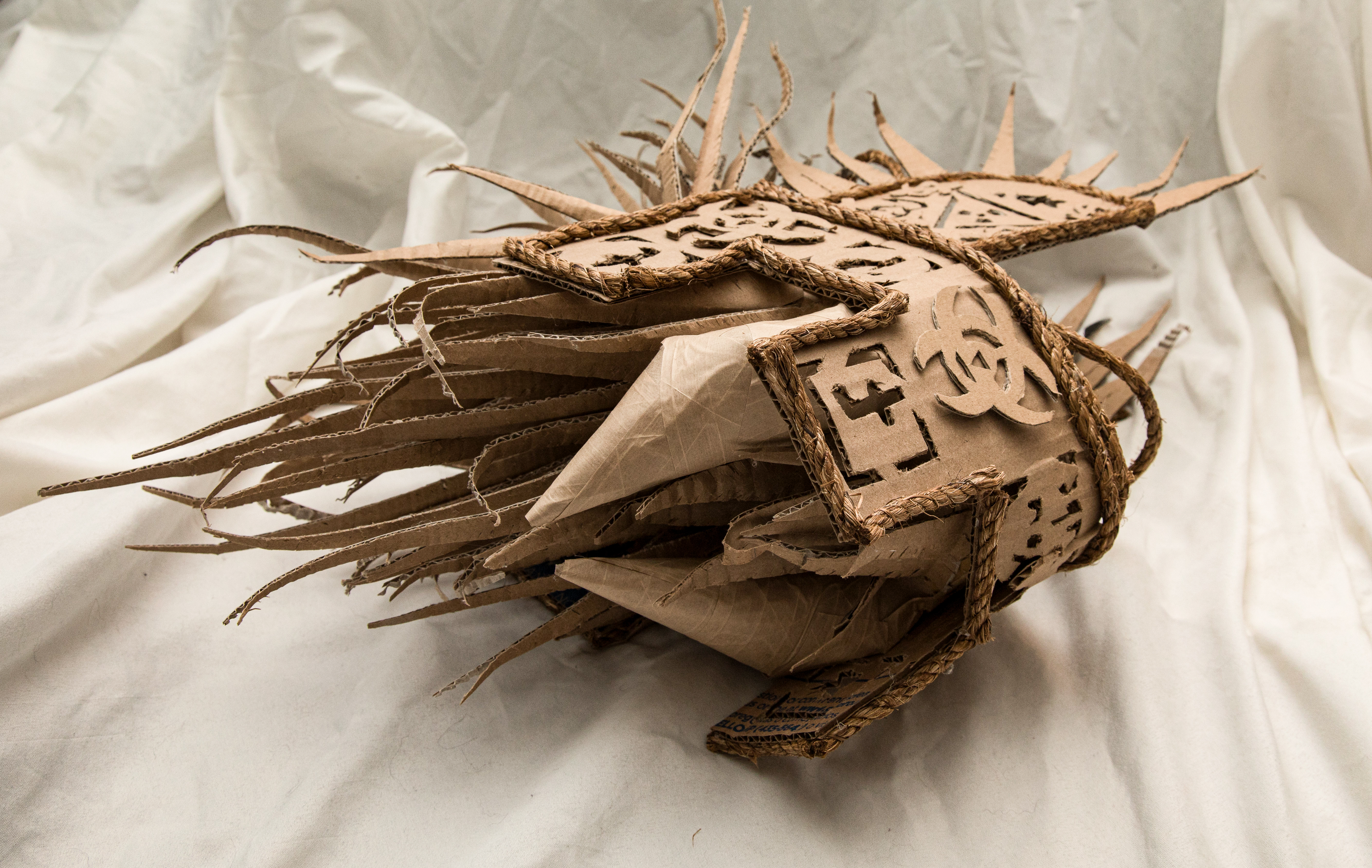 3D cardboard and twine helmet sculpture