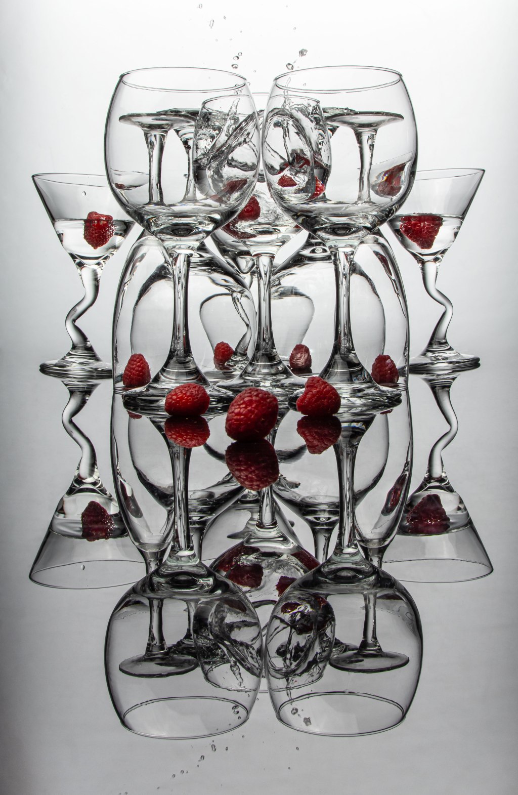 art photography, wine and martini glasses with raspberries and reflection, abstract art